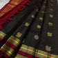 Folded black Kanchipuram silk saree with antique gold zari checks and maroon border
