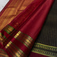 Angled black Kanchipuram silk saree showing antique gold zari checks with woven butta motifs and maroon border