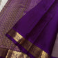 Draped mauve Kanchipuram silk saree with purple zari woven border and tassels, shown with pallu spread, available in the USA.