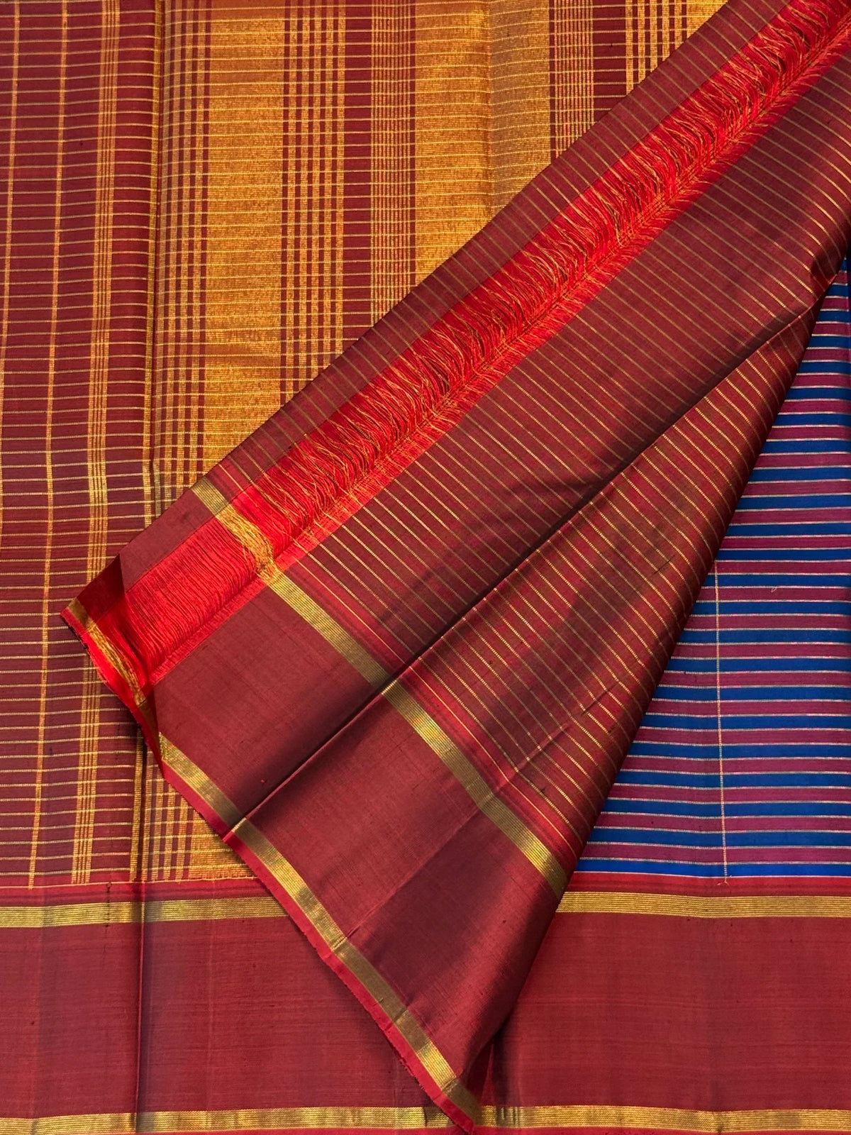 Cobalt blue and maroon handwoven Pure Silk Kancheepuram Kanchi Kattam saree with fine gold grid and red Rettapet border, pallu detail