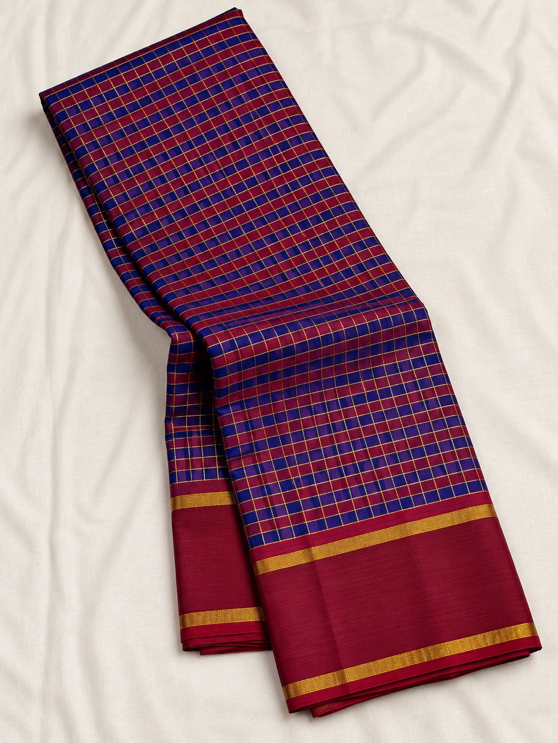 Cobalt blue and maroon handwoven Pure Silk Kancheepuram Kanchi Kattam saree with fine gold grid and red Rettapet border, folded silk detail