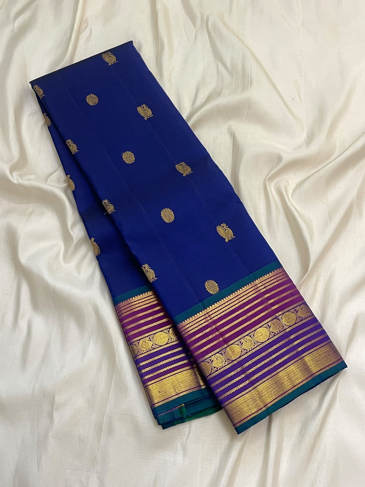 Purple-toned Kanjeevaram pallu with dense all-over gold zari field and ornamental bands