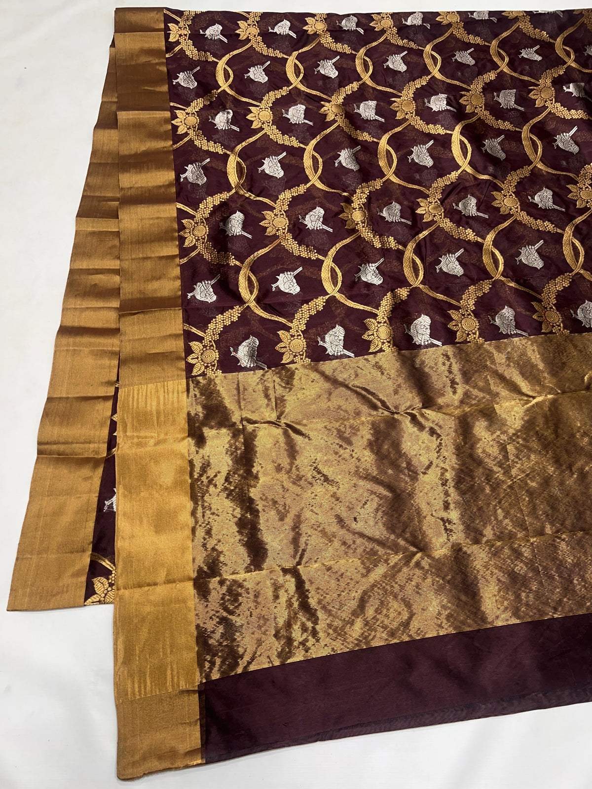 Deep Cocoa Brown Pattu Silk Chanderi saree detail with luminous antique-gold weaving.