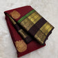 Coffee-brown rettapet border with green highlights on the arakku red saree.