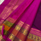 Coffee-brown rettapet border with green highlight lines on the fuchsia pink saree.