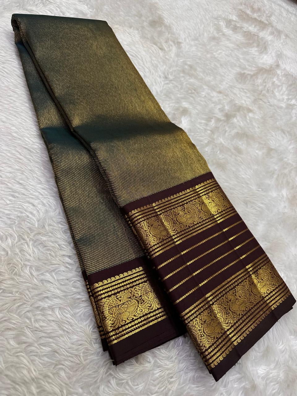 Handwoven pure silk Kanchipuram butta saree in coffee brown with a dense diagonal zari weave.