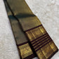 Pure silk texture of the coffee brown Kanchipuram saree.