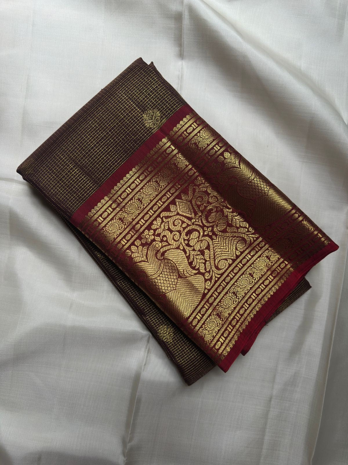 Deep Coffee Brown Zari Kattam silk with petite gold buttas and broad Gandaberunda zari border in Arakku Red.