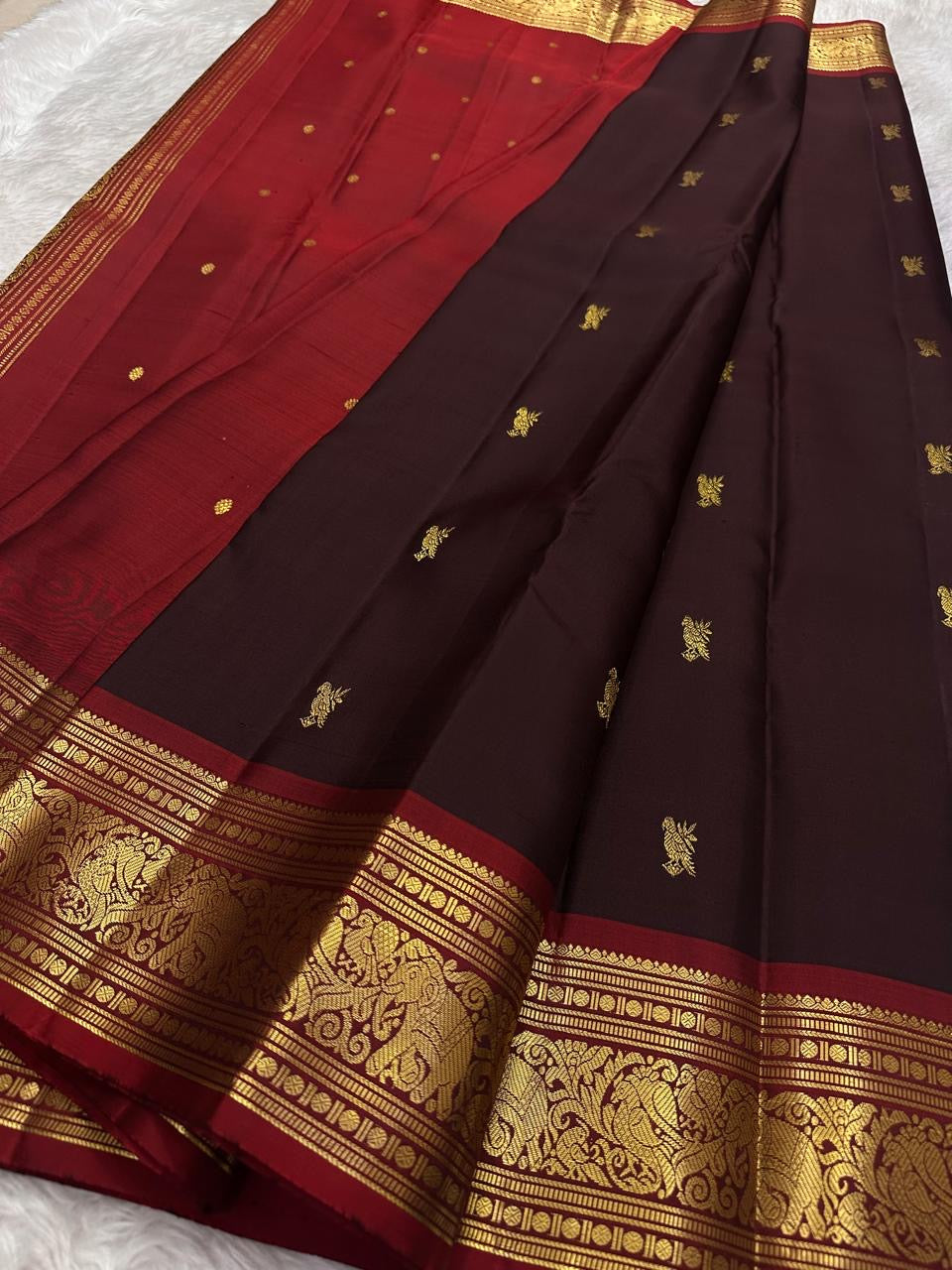 Midnight black Kanchipuram silk saree with traditional gold zari butta detail