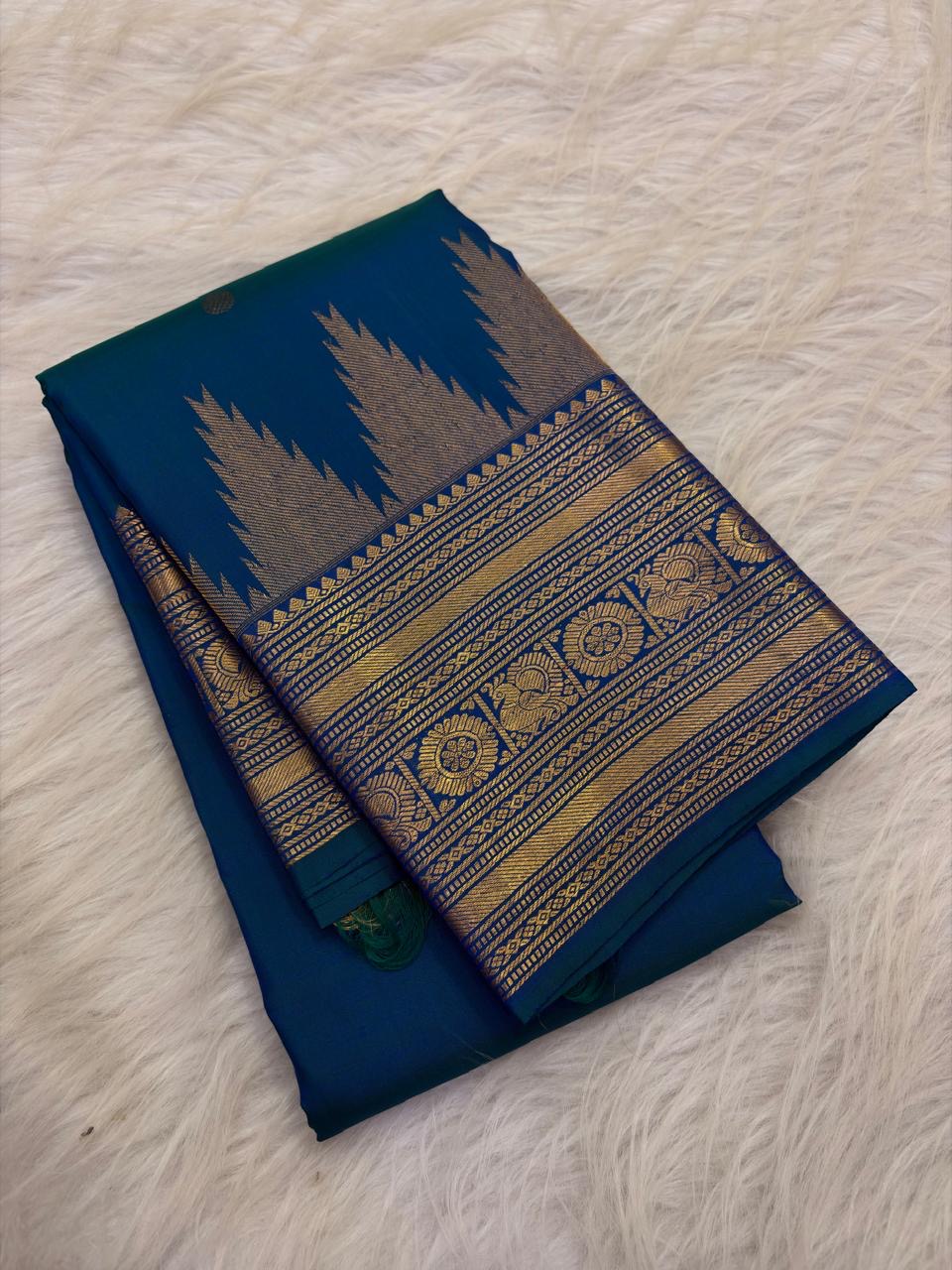 Peacock Blue Thazampoo Reku pure silk Kanchipuram saree, woven buttas, showing deep oceanic peacock blue with a teal-green glimmer, royal blue border accents and antique-gold zari
