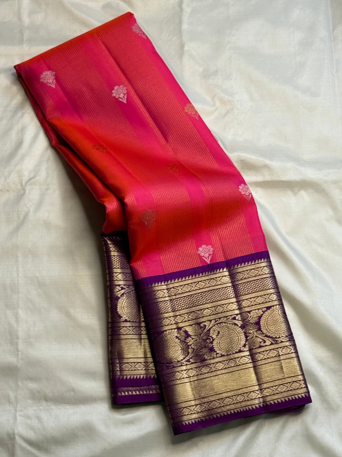 Coral-amethyst shot colour Pure Silk Kanjivaram Korvai saree with alternating Sona Rupa floral buttas.