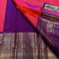 Coral-amethyst Korvai Kanchipuram saree showing deep purple stacked zari border.
