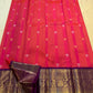 Full handwoven Kanjivaram saree with luminous coral body and amethyst-violet contrast sections.