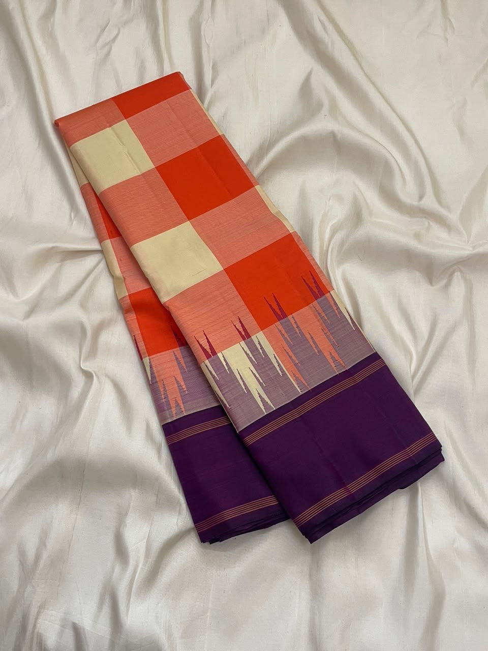 Coral orange and ivory Kanchi Kattam saree with deep violet pallu