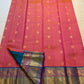 Full view of the coral sunset-orange Kanjivaram Zari Kattam saree with turquoise border
