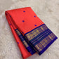 Coral orange Kanjivaram silk saree with royal violet korvai border – drape view
