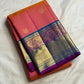 Coral-orange Pure Silk Kanchipuram saree draped, showing the fine Zari Kattam grid