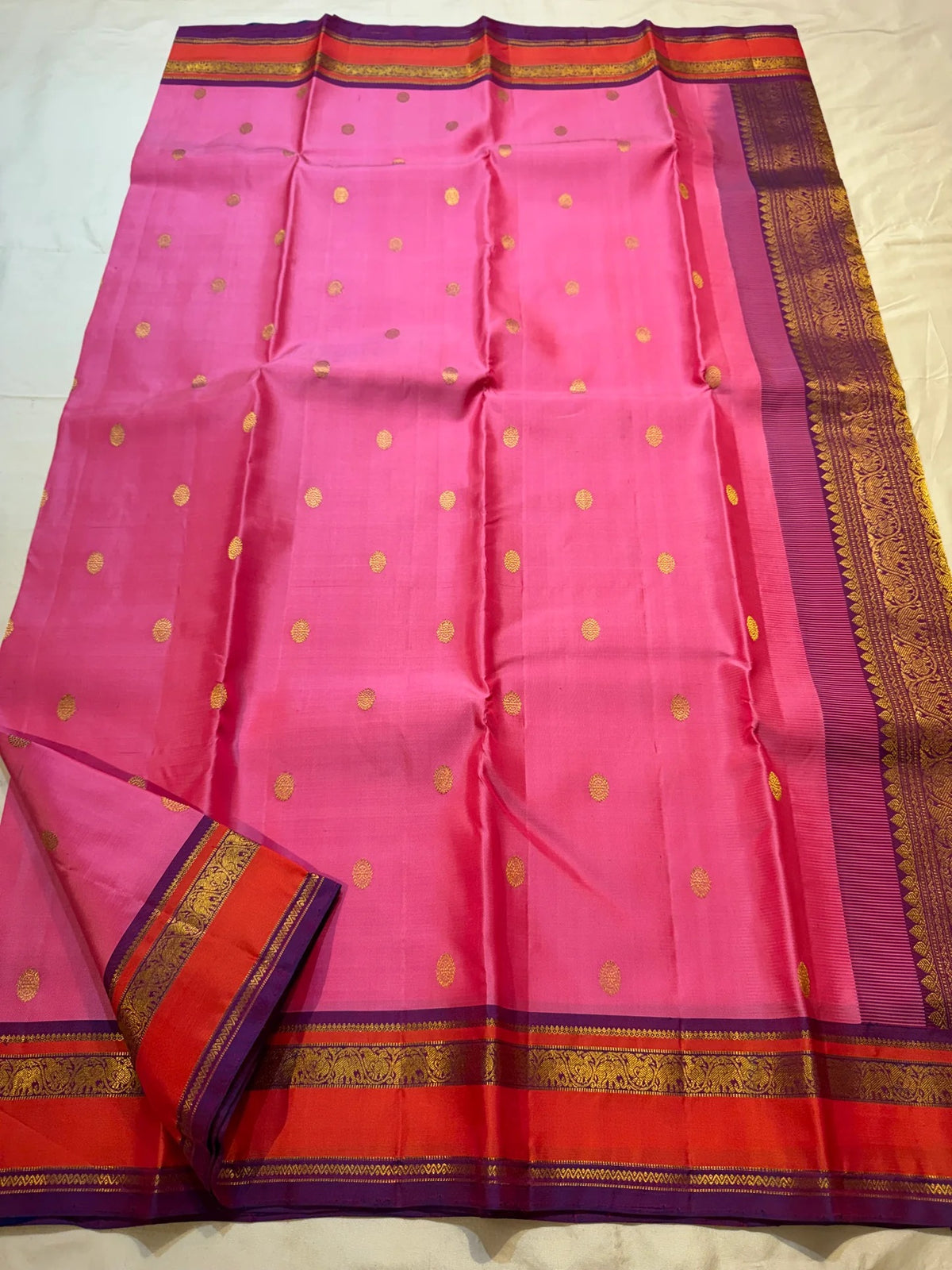 Detail of the coral-orange and purple border on the rose pink Kanchipuram saree