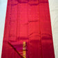 Pink-orange silk fold showing the colour shift across the handwoven surface beside gold zari