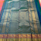 Detail of the turquoise zari border on the coral-orange Kanchipuram Zari Kattam saree