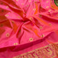 Coral Pink Chanderi silk saree showing Emerald Green ornamental border and intricate gold weaving