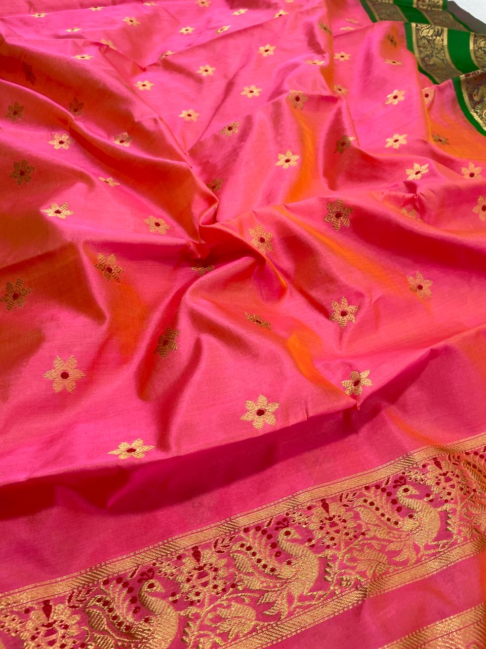 Coral Pink Chanderi silk saree showing Emerald Green ornamental border and intricate gold weaving