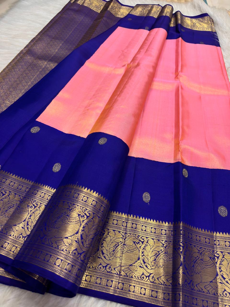 Coral Pink Kanjeevaram silk saree with Deep Royal Blue peacock zari border