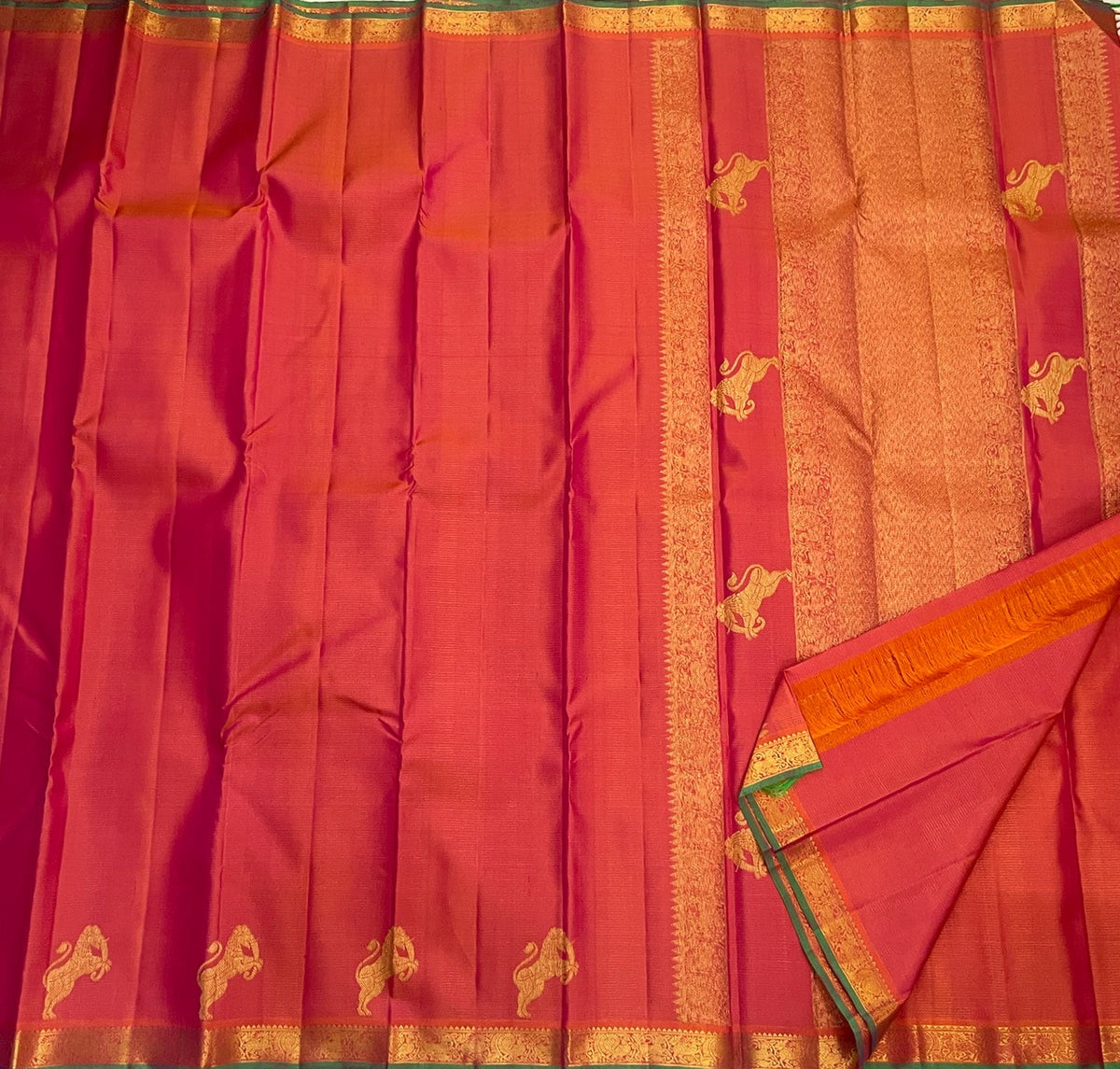 Coral Rose pure silk Vairaoosi saree with traditional gold zari border and contrasting green edge.