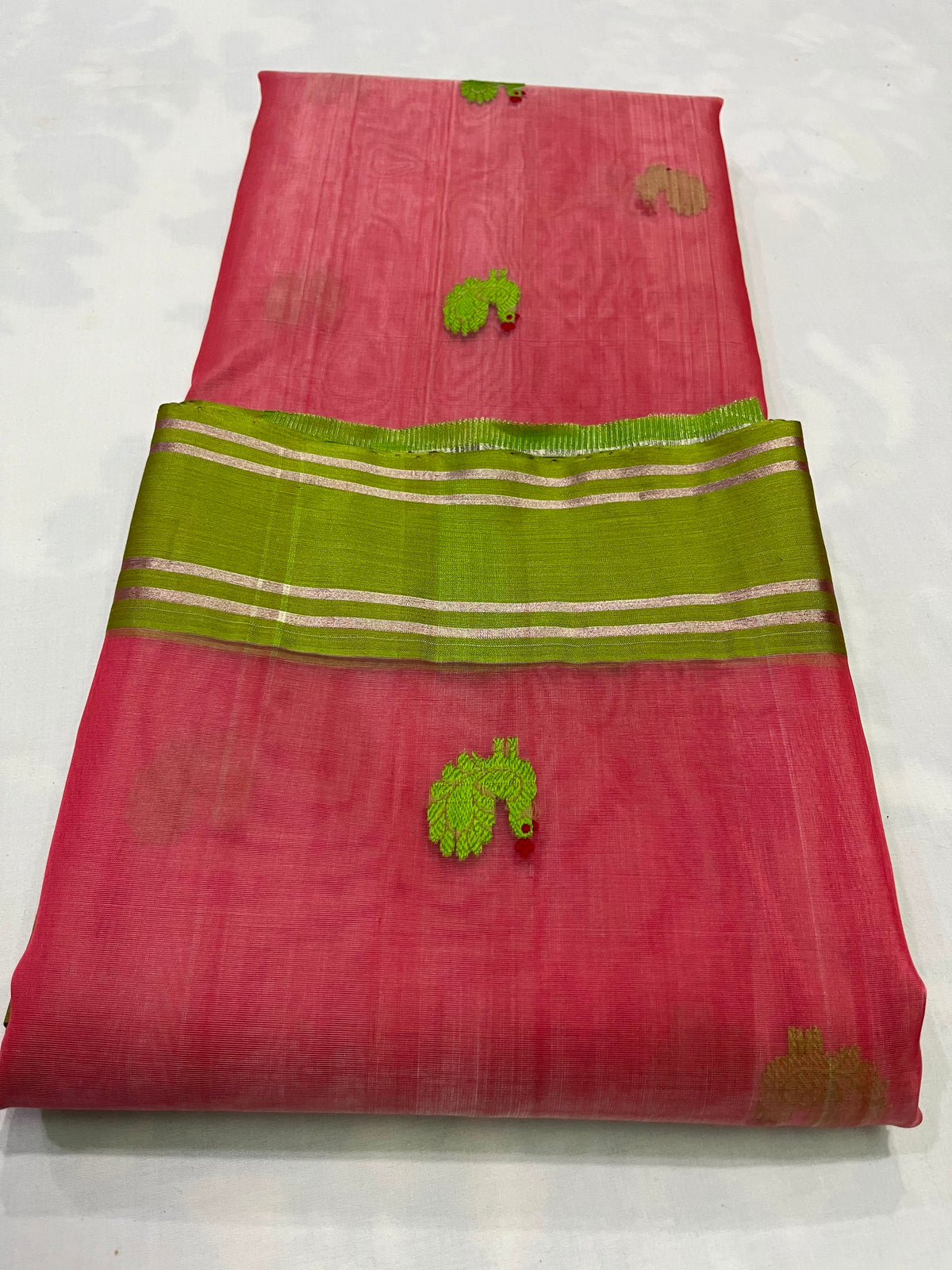 Coral pink Chanderi silk saree with a vivid parrot green border