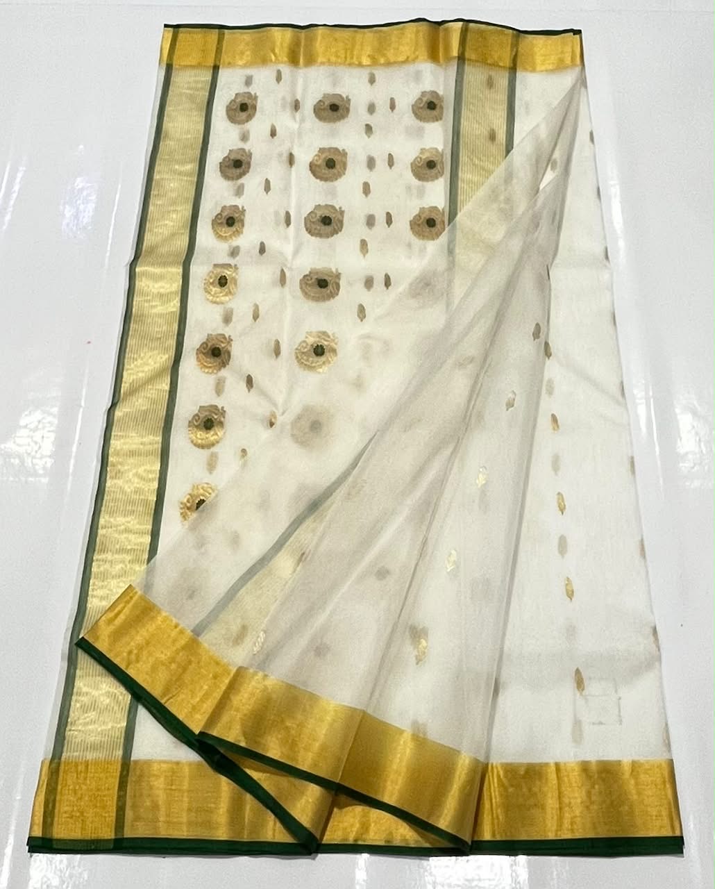 Ivory Katan Silk Chanderi saree border detail with gold-tone weaving and fine Emerald Green edging.