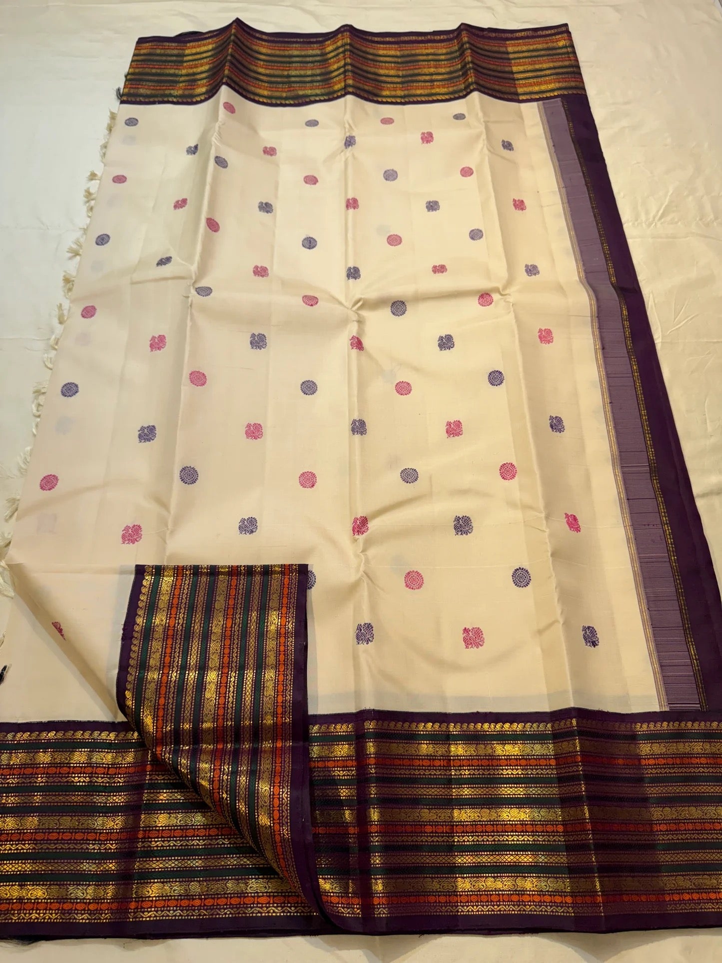 Two-colour royal purple and pink silk thread butta close-up on cream ivory Kanchipuram pure silk saree — Idam Living