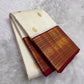 Warm ivory Pure Silk Kanjipuram Korvai saree with a deep Arakku-red and classic-gold zari border.