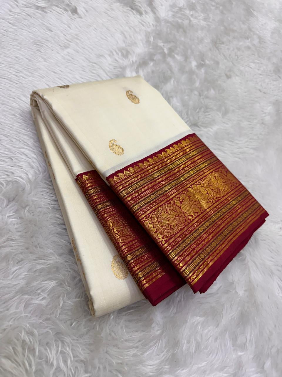 Warm ivory Pure Silk Kanjipuram Korvai saree with a deep Arakku-red and classic-gold zari border.