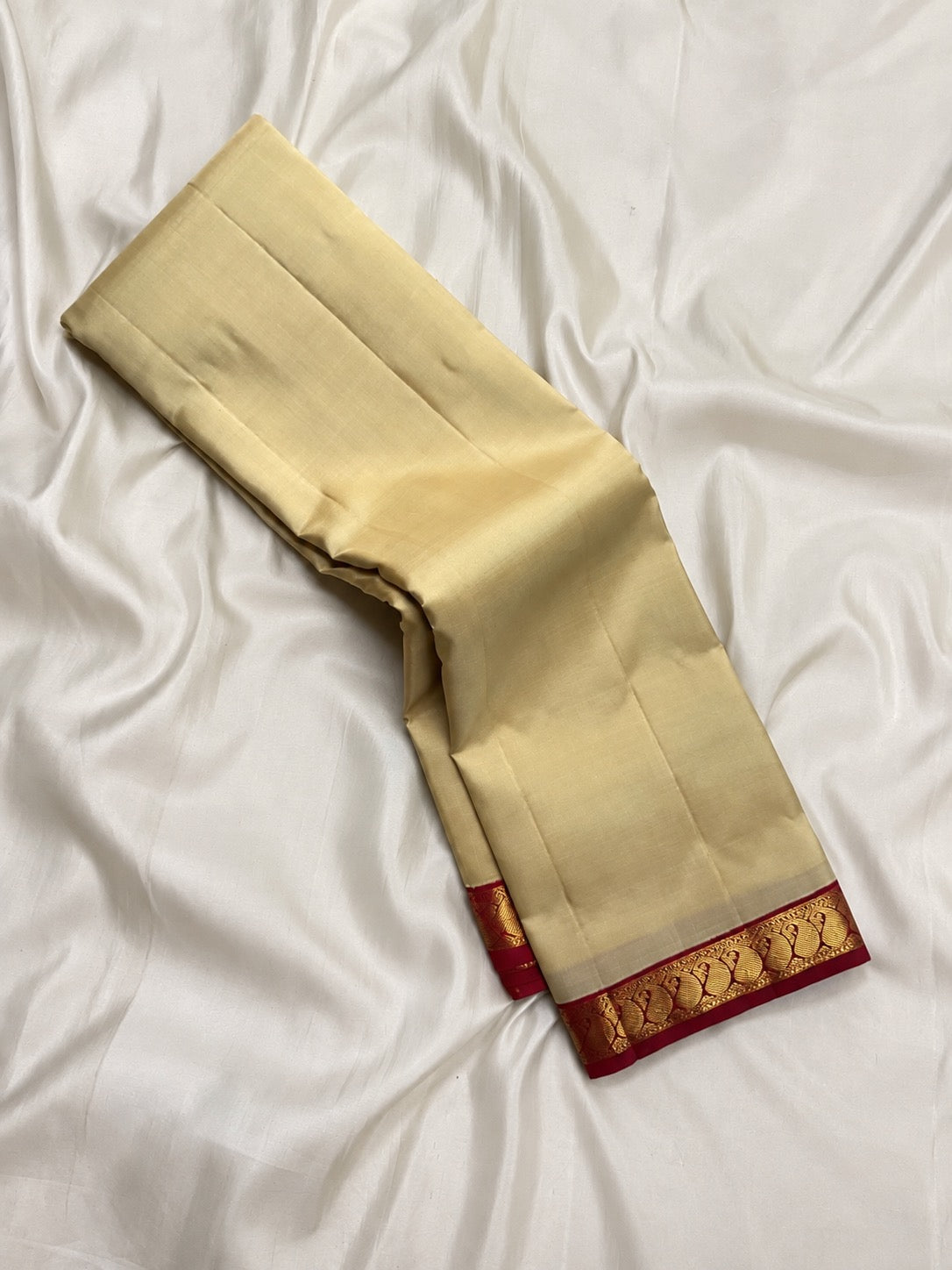 Kanchipuram cream Korvai saree with red Paisley zari border