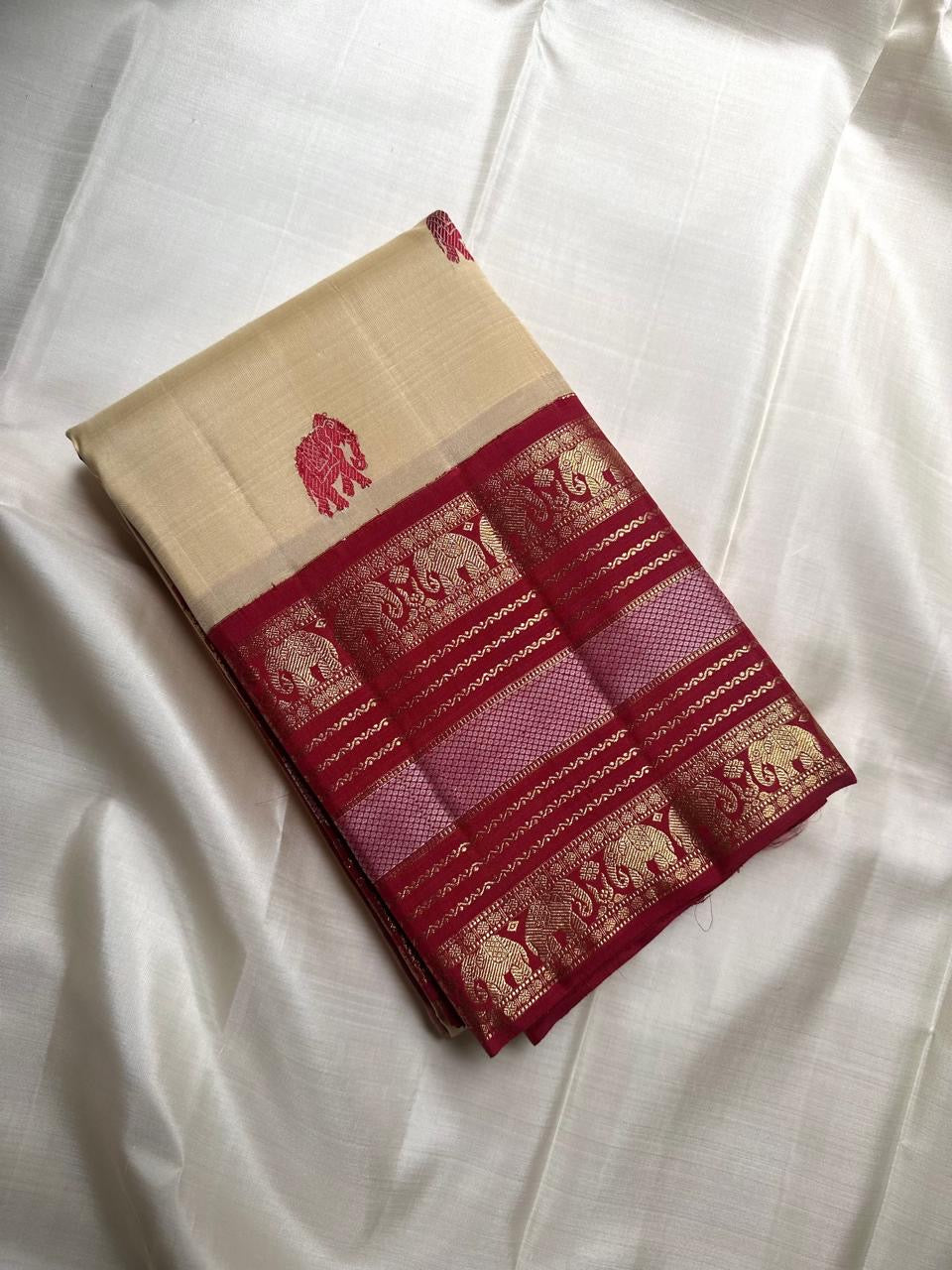 Cream Kanchipuram silk saree with maroon red Varisaipet elephant motif border, full view