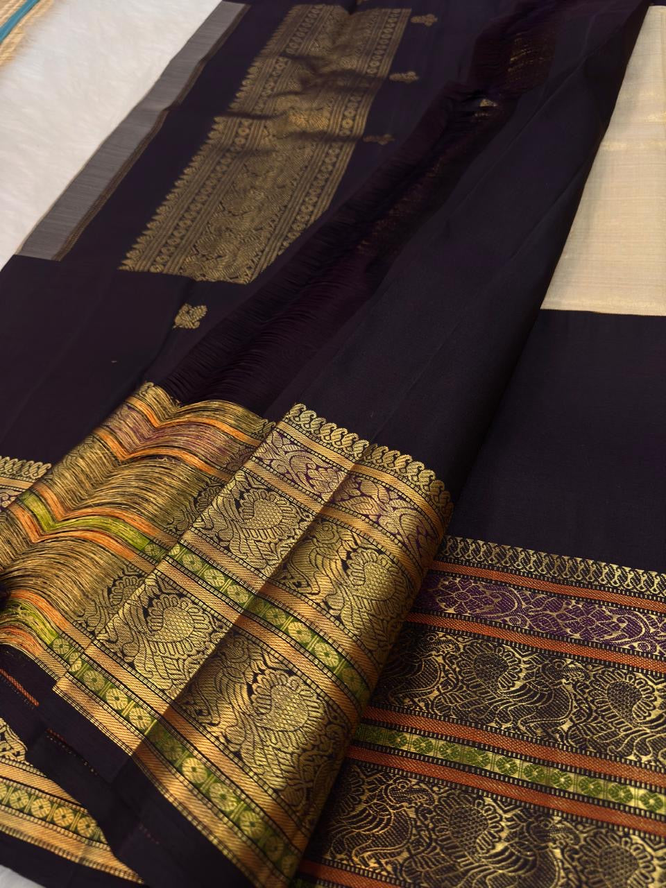 Cream Kanjeevaram saree with stacked gold zari border