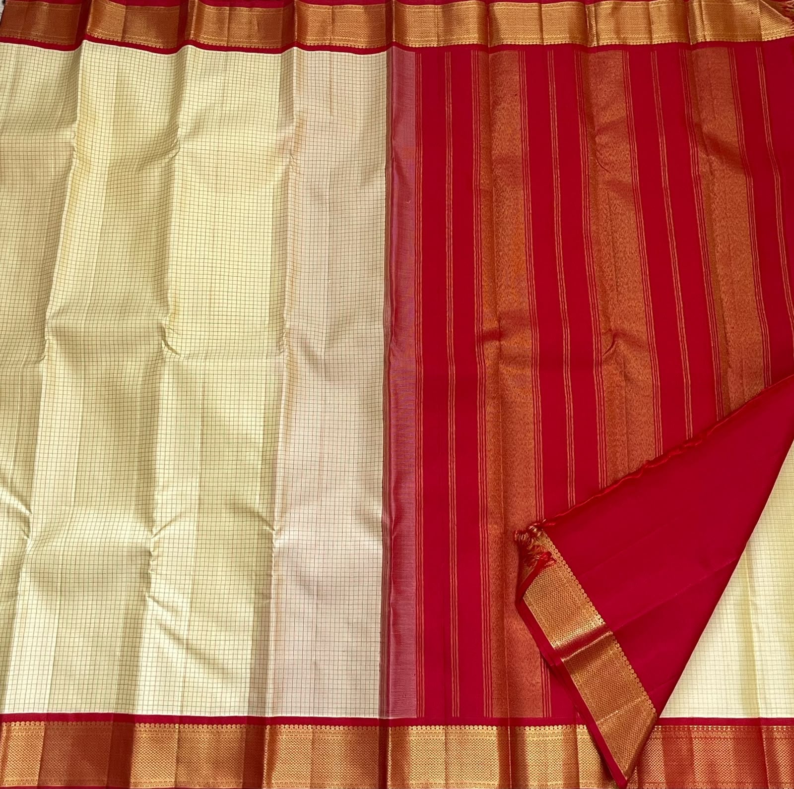 Cream body close-up showing red pinstripe checks