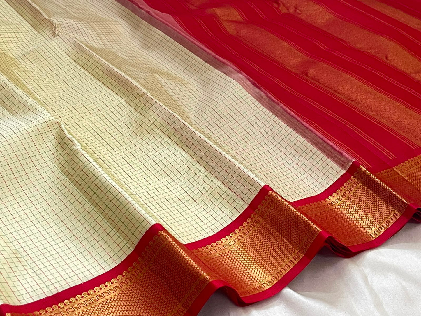 Red border with gold zari diamond lattice detail