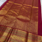 Close view of warm ivory silk meeting a deep red Korvai border with stylised bird and circular medallion forms.