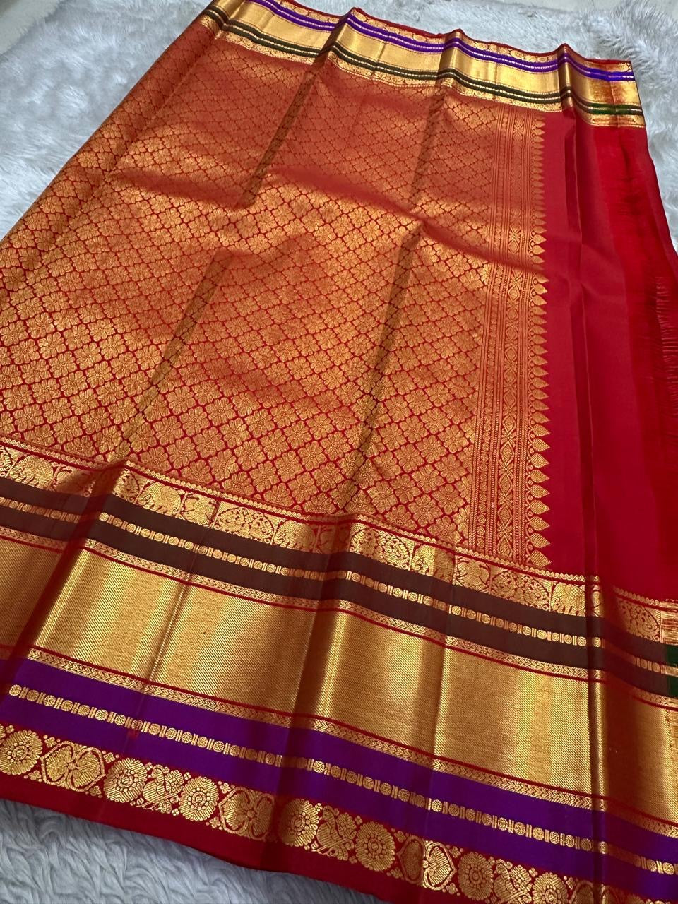 Close-up of the red pallu with dense gold zari motifs and the wide zari border with purple band, shipped from New Jersey USA.