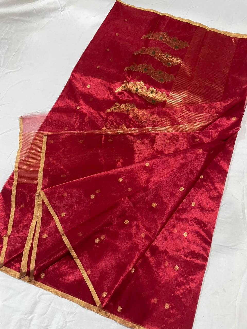Close-up of gold floral buttas on the Crimson Red Jari Silk Chanderi saree