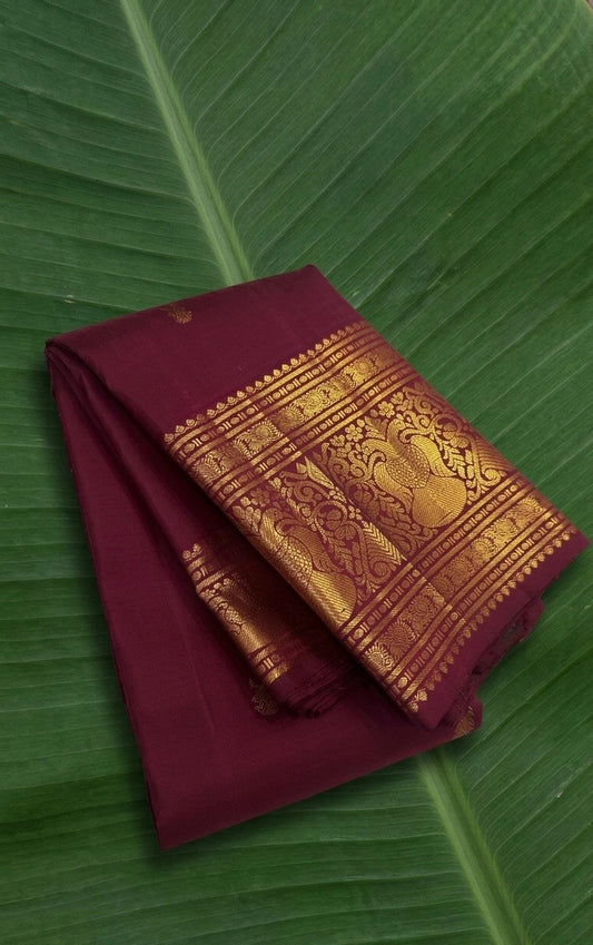 Crimson plum arakku Kanchipuram silk saree with antique gold Gandaberunda border by Idam Living