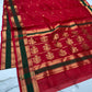 Crimson red Katan Silk Chanderi saree with forest green border framed by gold zari bands