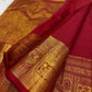 Crimson Red Handwoven Pure Silk Kanchipuram Saree with Ornate Zari Buttas and Gold Border – silk fabric close-up