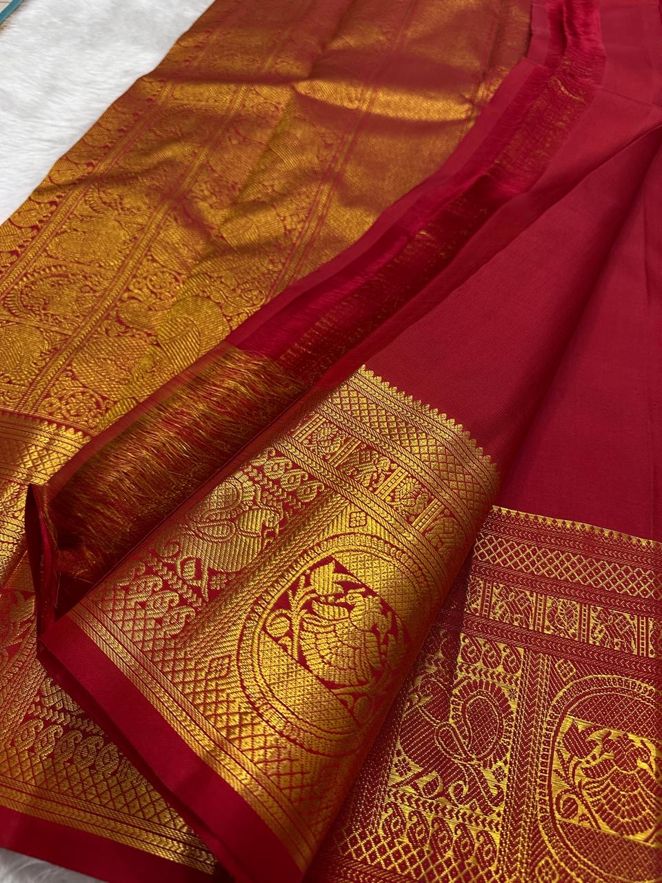 Crimson Red Handwoven Pure Silk Kanchipuram Saree with Ornate Zari Buttas and Gold Border – silk fabric close-up