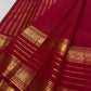 Vermilion Pinkish Red silk fold catching light beside handwoven gold zari buttas and border