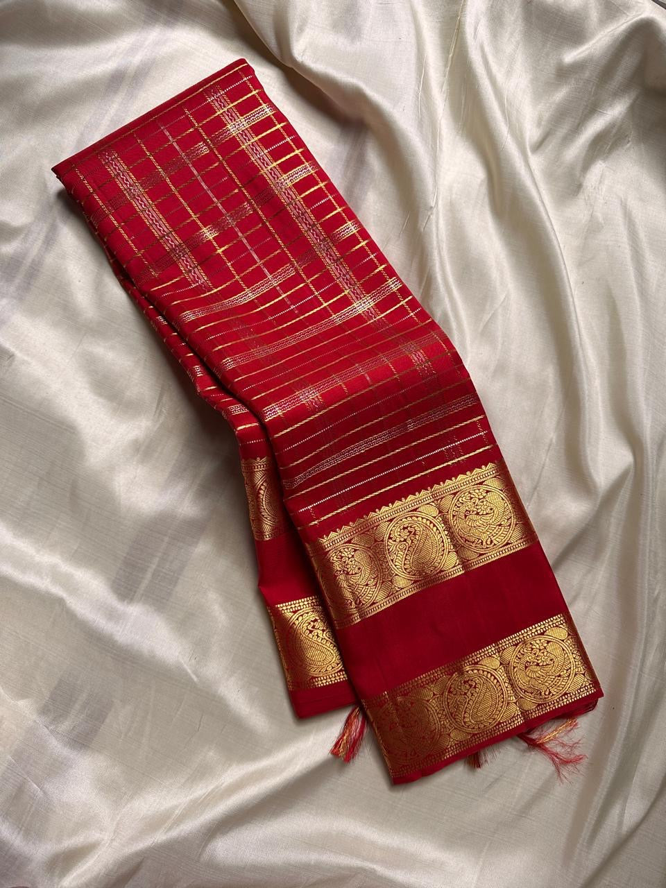 Crimson Red Kanchipuram Zari Kattam pallu with dense gold zari geometry and a large Sorgavasal Mayil and Manga border.