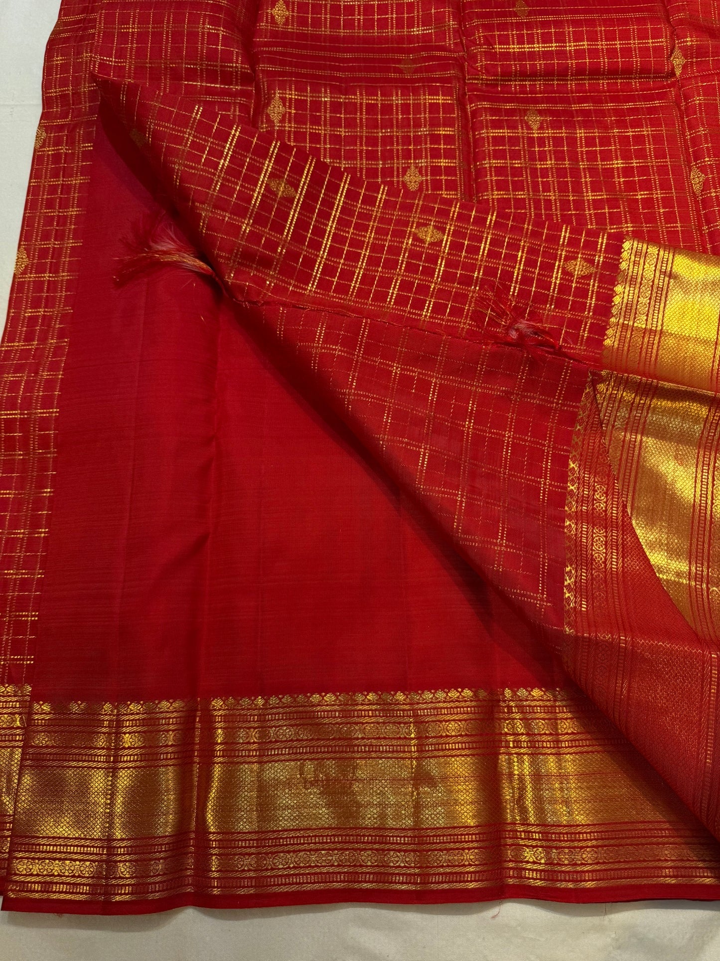 Close-up of maanga butta paisley in gold zari on crimson red Kanchipuram silk saree — Idam Living