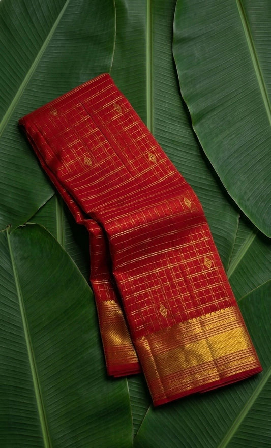 Crimson red handwoven Kanchipuram pure silk saree with zari kattam body and maanga butta on banana leaf — Idam Living