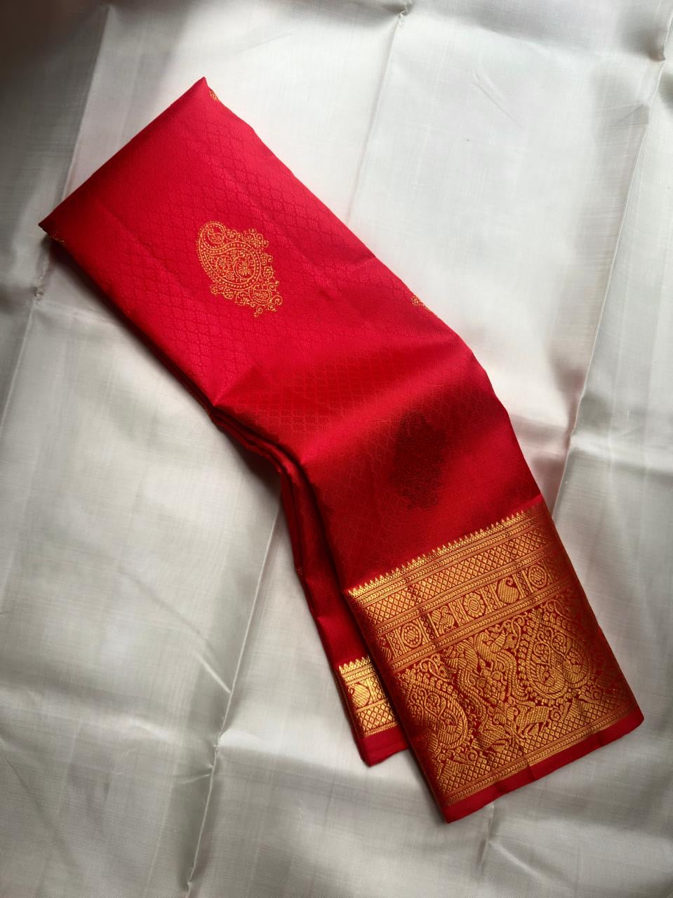 Crimson Red Handwoven Pure Silk Kanchipuram Saree with Ornate Zari Buttas and Gold Border – silk body weave close-up